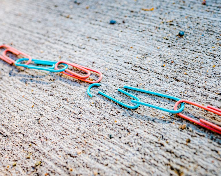 blue green and red plastic clothes pin