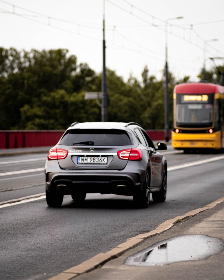 black and red car on road during daytime