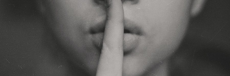 grayscale photo of woman doing silent hand sign