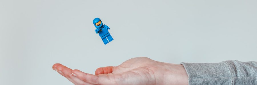 person holding blue lego toy